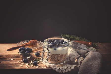 Muesli with yogurt and blue berries in glass jar.の写真素材