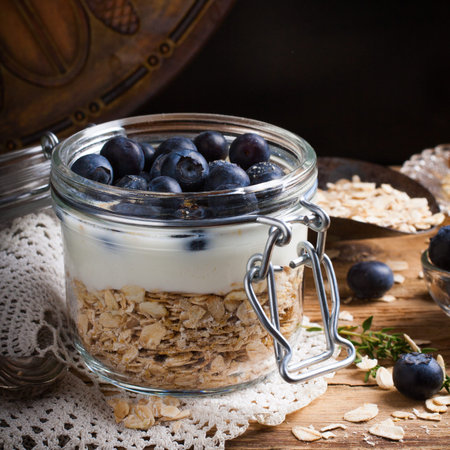 Muesli with yogurt and blue berries in glass jar.の写真素材