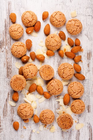 Italian almond cookie amaretti and almonds on white vintage table, food cocept, top view.の写真素材