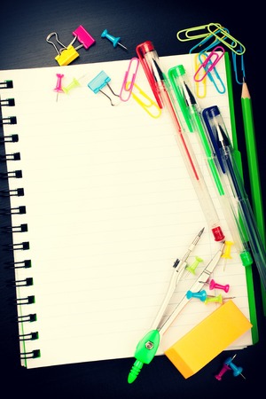 School education background with blank exercise book with copy space. Back to school concept. Top view. Retro style toned.の写真素材