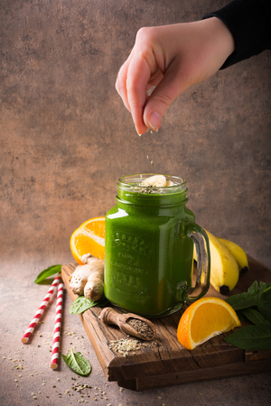 Healthy green smoothie  in mason jar and ingredients on old wood. Detox, diet, healthy, vegetarian food concept with copy space.の写真素材