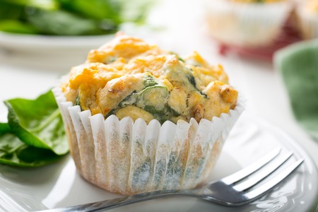 Muffins with spinach, sweet potatoes and cheese on white background. Healthy food concept.の写真素材