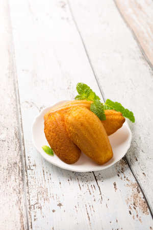 Homemade lemon cookies Madeleine with mint. Holidays food concept with copy space.
