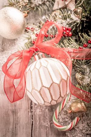 Colorful Christmas ball and decoration with christmas tree on old wooden background. Winter holiday concept with copy space. Retro style toned.の写真素材