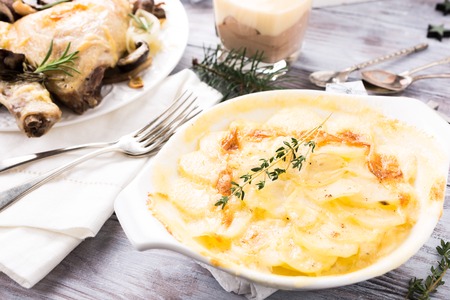Delicious Christmas themed dinner table with potato gratin. Holiday concept.の写真素材