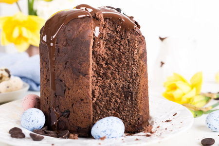 Easter orthodox sweet chocolate bread and colorful quail eggs on white background. Easter holidays...