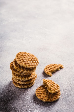 Glass cups of coffee with mini stroopwafel, syrupwaffles cookies on light gray background with copy space. Retro style toned.の写真素材