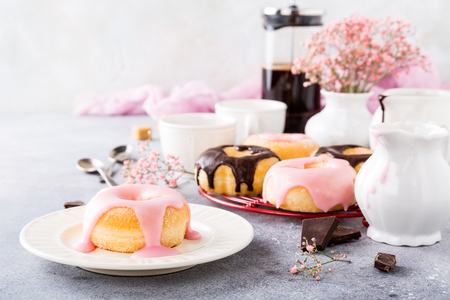 Homemade doughnuts with pink glaze on light gray background. Selective focus. Copy space.の写真素材