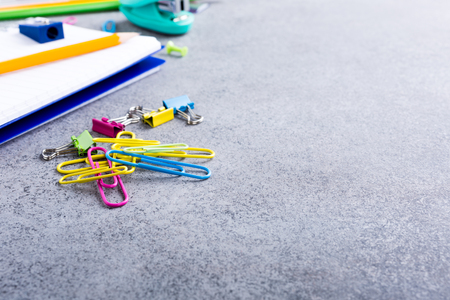 Background with assorted colorful school supplies on gray stone table. Concept with copy space.の写真素材