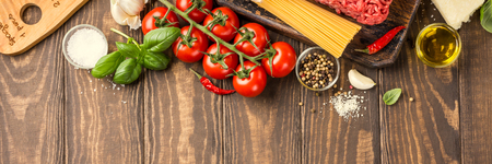 Ingredients for spaghetti Bolognaise or Bolognese with savory minced beef and tomato, basil and spices. Italian healthy food background with copy space. Banner. Top view.の写真素材