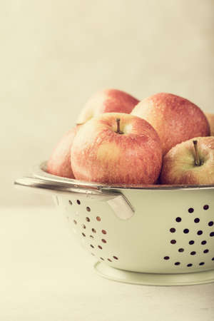 Fresh apples in metal strainerの写真素材
