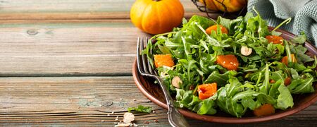 Delicious salad with arugula and baked pumpkinの写真素材