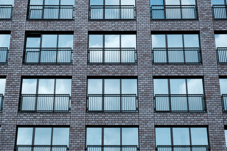 Modern office brick building window facade with cloudy sky reflection. Industrial Background and...