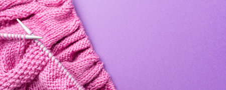 Banner with Knitting flat lay with pink wool yarn and knit accessories over lilac, top view,...