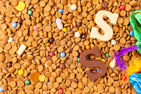 Background for Dutch holiday Sinterklaas with chocolate letter, kruidnoten cookies and traditional hollands sweets. Concept for children party Saint Nicholas day five december. Top viewの写真素材