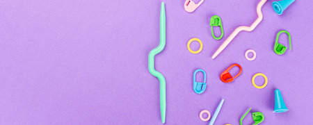 Banner with colorful crochet and knitting tools and accesories ober purple background. Overhead shot, top view with copy spaceの写真素材