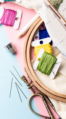 Vibrant embroidery threads and essential tools are beautifully arranged in a creative workspace,...