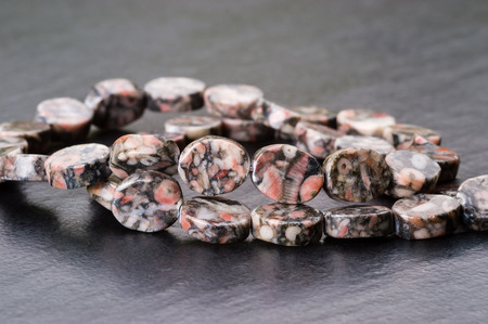 Strand of fossil jasper colorful oval beads.の写真素材