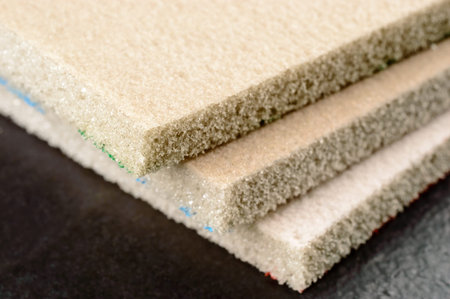 Sanding sponges on black stone. Very fine grade for last touch.
