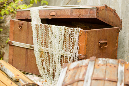 Open treasure trunk or chest with debris and junk from the sea.の写真素材