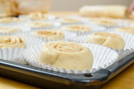 Raw, unbaked buns in dispoable paper baking cups.