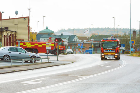 Ronneby, Sweden - October 26, 2014: Emergency call for firefighters. Scania trucks leave station...