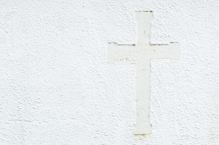 Embossed christian cross on church stone wall in white. Cross to the right in picture and place for text to the left.の写真素材