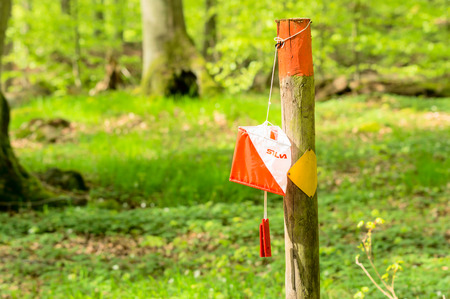 RONNEBY, SWEDEN - May 11, 2015: Silva brand orientation control on trail marker in the forest. Silva is known for selling compasses and running watches.のeditorial素材