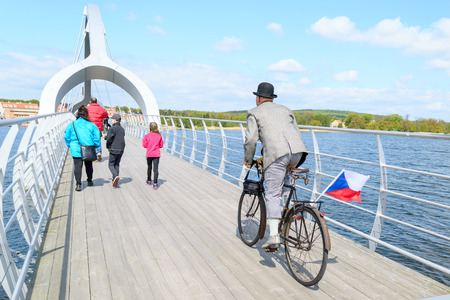 Solvesborg, Sweden - May 16, 2015: International Veteran Cycle Association (IVCA) 35th rally. Costume ride through public streets in town. Man leaving bridge.のeditorial素材