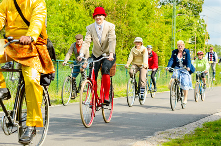 Solvesborg, Sweden - May 16, 2015: International Veteran Cycle Association (IVCA) 35th rally. Costume ride through public streets in town. Persons on old bikes.のeditorial素材