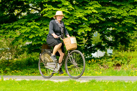 Solvesborg, Sweden - May 16, 2015: International Veteran Cycle Association (IVCA) 35th rally. Costume ride through public streets in town. Ride through park.のeditorial素材