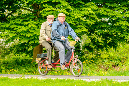 Solvesborg, Sweden - May 16, 2015: International Veteran Cycle Association (IVCA) 35th rally. Costume ride through public streets in town. Ride through park.のeditorial素材