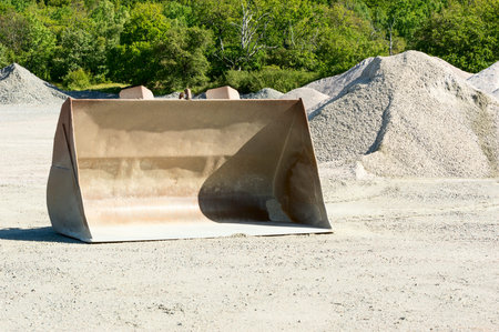 One empty loading bucket left in gravel pit after use.の写真素材