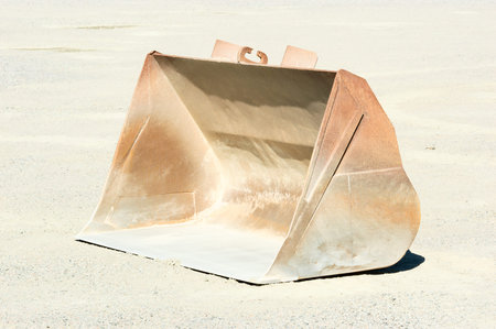One empty loading bucket left in gravel pit after use.
