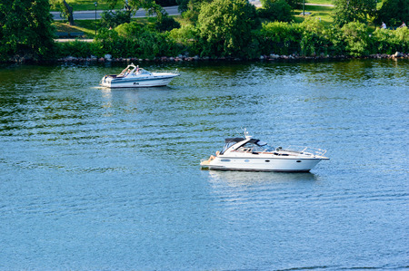 Stockholm, Sweden - July 05, 2015: Two boats in the central parts of Stockholm. People onboard relax and enjoy the sun.のeditorial素材