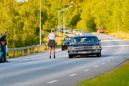 Ronneby, Sweden - June 26, 2015: Car break down and cause some chaos on the street during a road cruise for veteran cars. Drunk passengers behave unsafe and venture into street.のeditorial素材