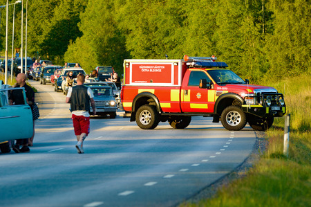 Ronneby, Sweden - June 26, 2015: Car break down and cause some chaos on the street during a road cruise for veteran cars. Drunk passengers behave unsafe and venture into street.のeditorial素材