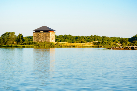 Old wartime storage building. These buildings are located far from houses, often on islands, and were used to store gunpowder and other wartime necessities. Morning sun gives a warm feeling.の写真素材