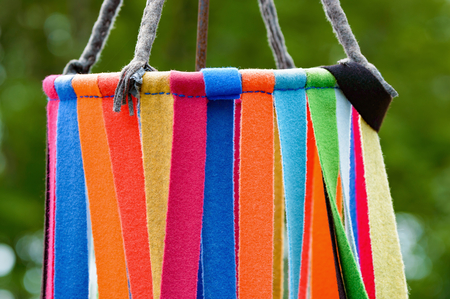 Rainbow of color on this soft chime or dream catcher made of stripes of cloth.の写真素材