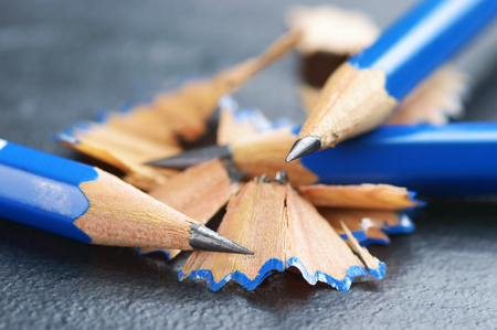 Blue graphite pencils with shavings on dark stone surface. Close up of this universal and powerful tool for artists, writers and students. Also a symbol of intellect, learning and literacy.の写真素材