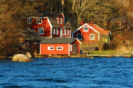 Ronneby, Sweden - December 30, 2015: Lovely red homestead close to water. A law demanding repayment on mortgages is suggested to start by may 1 2016 in Sweden.のeditorial素材