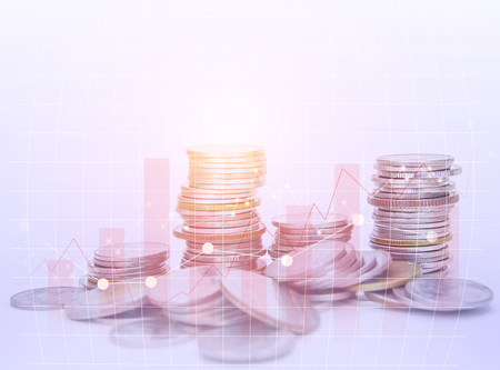 Rows coins for finance and banking concept on white background, color filter, graphs and chartの写真素材