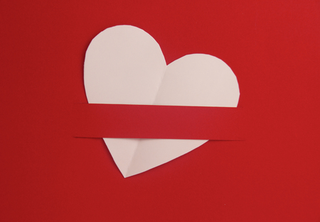 Heart shaped white paper in red background, Heart cut from white paper background, Valentines Day background, Holiday Card,の写真素材