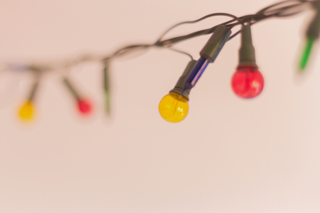 Christmas lights, Closeup, Christmas background with lights, Christmas lights border, Glowing colorful Christmas lights on backgroundの写真素材