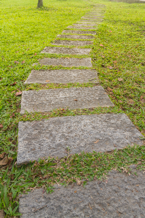 Curved sidewalk, path, trail at the empty street in the parkの写真素材