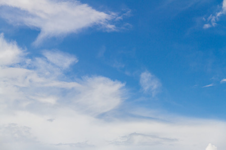 Blue sky background with white fluffy cloudsの写真素材