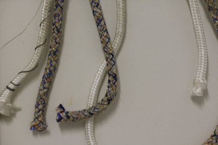 detail of colored ropes hanging on a wall