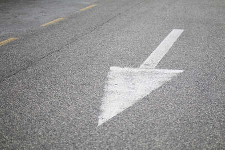 White arrow on the asphalt road in the city. High quality photoの写真素材