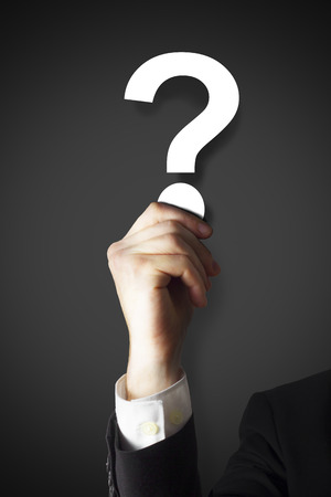 businessman holding question mark darkの写真素材