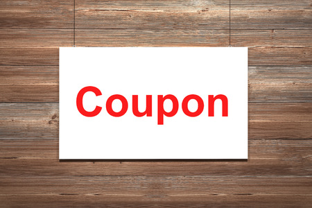 white canvas hanging on wooden wall couponの写真素材